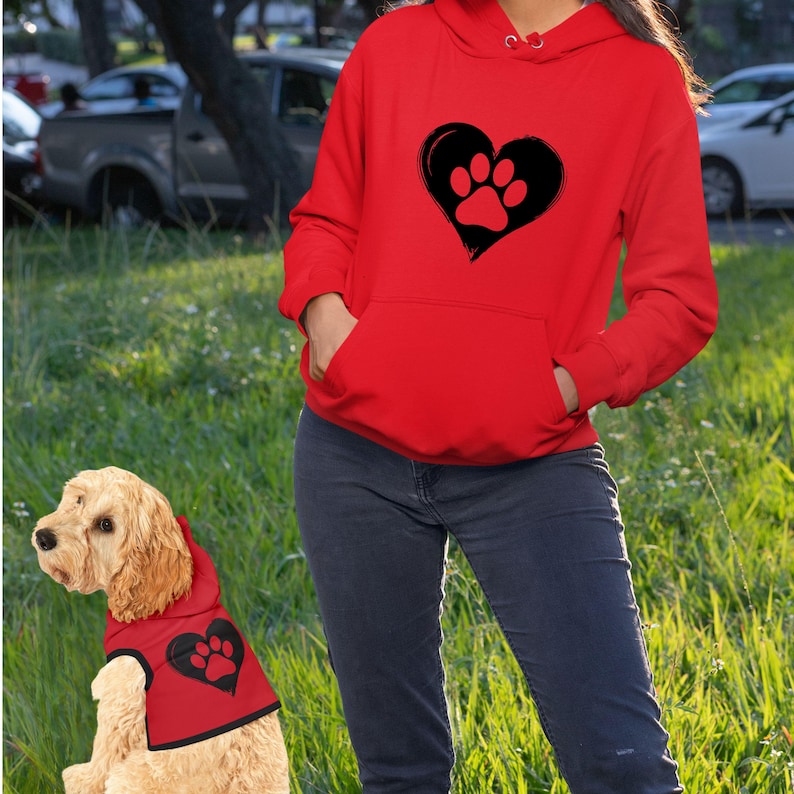 girl and dog wearing red hoodies