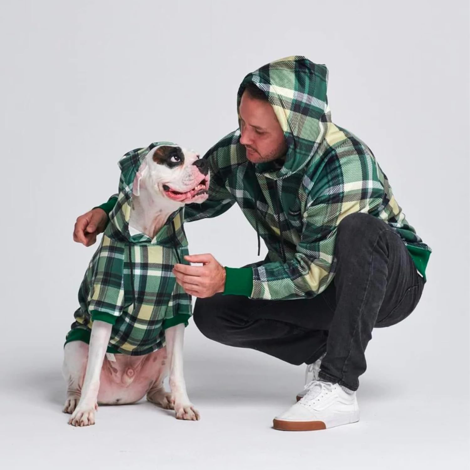 dog and owner wearing green hoodies