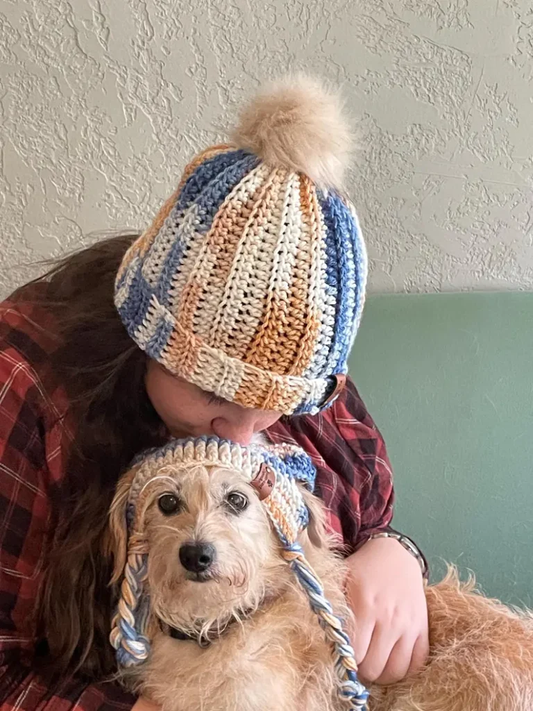 dog and woman wearing matching beanies