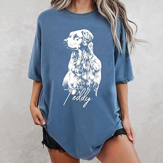 girl wearing blue shirt with picture of dog