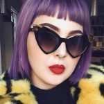 woman with purple hair wearing sunglasses