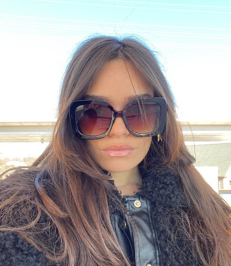 woman wearing large sunglasses