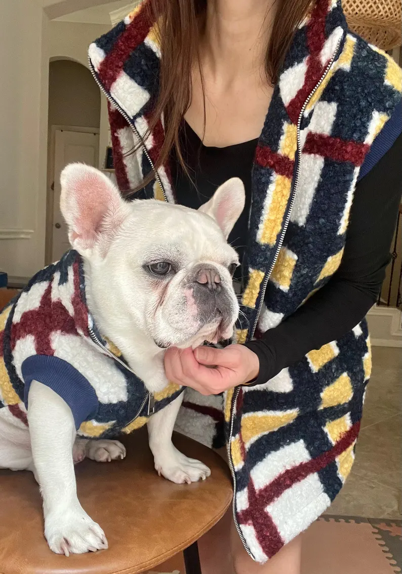 dog and owner wearing plaid vests