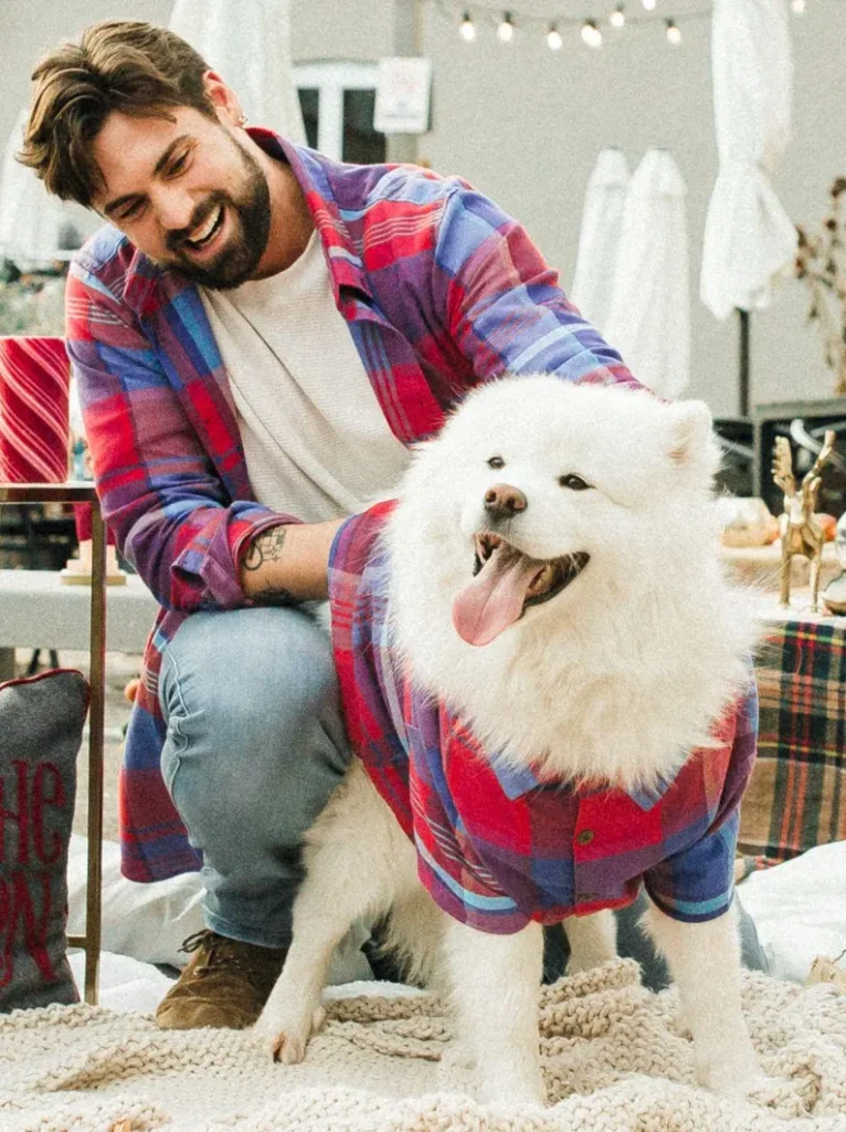 man and dog wearing matching shirts
