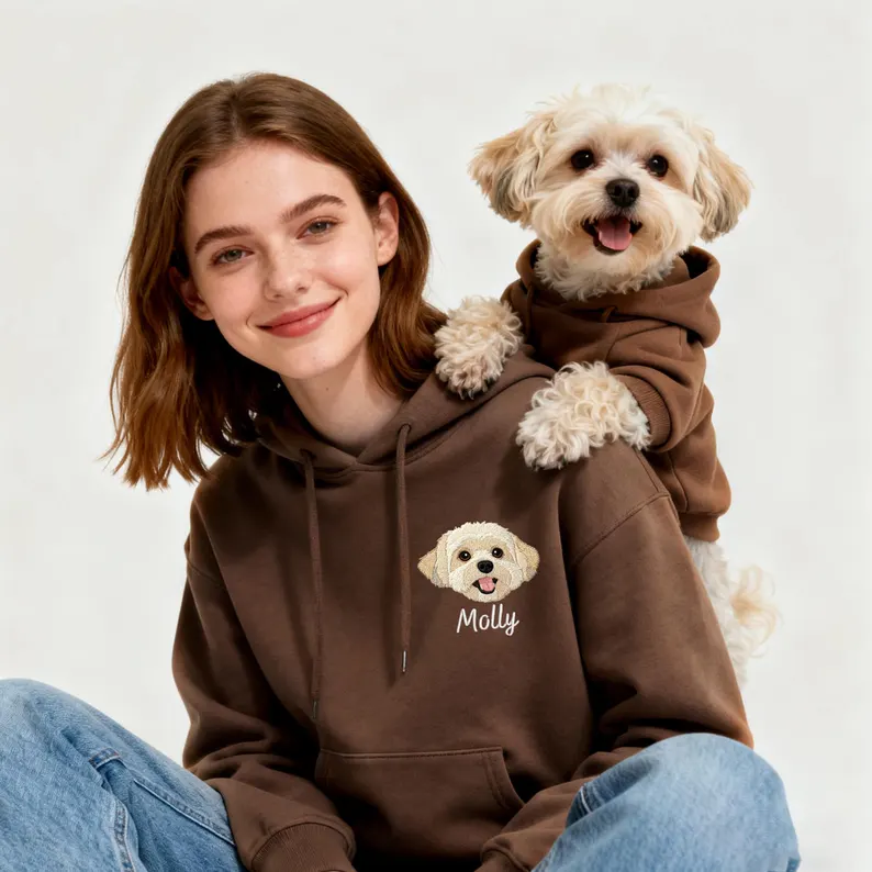 girl and dog wearing matching hoodies