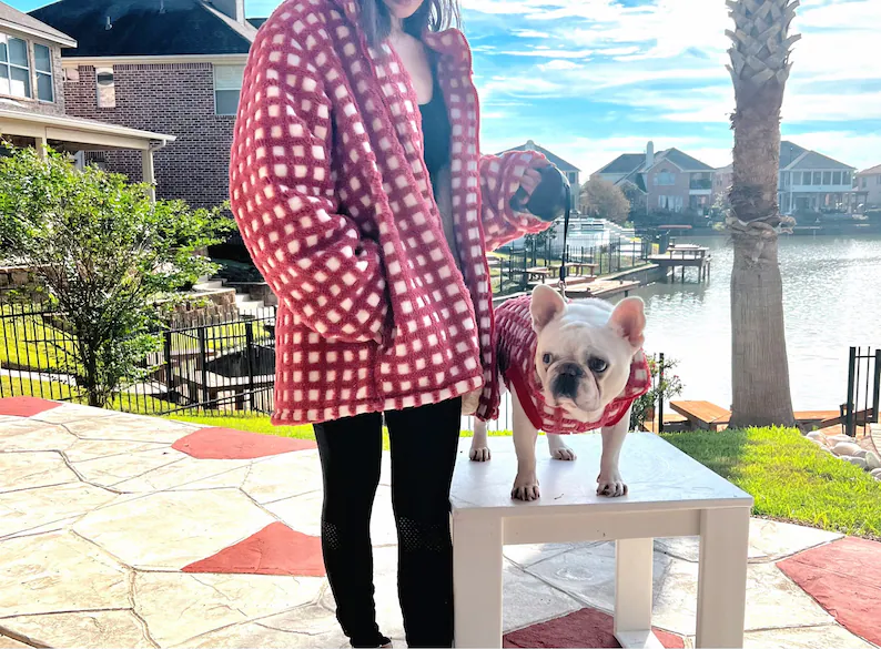 woman and dog wearing matching jackets