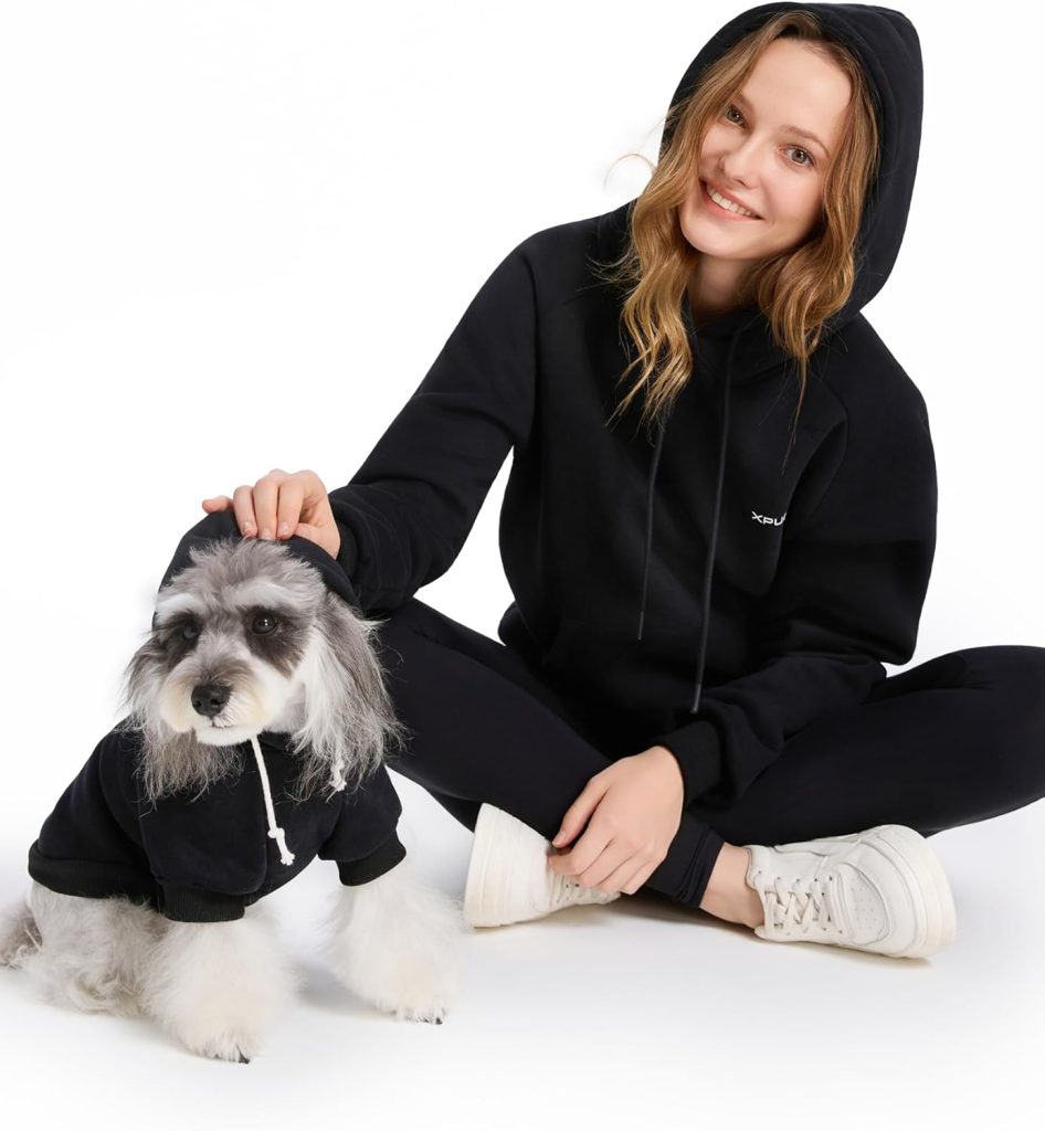 woman and dog wearing black hoodies