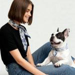 woman and dog wearing blue scarves