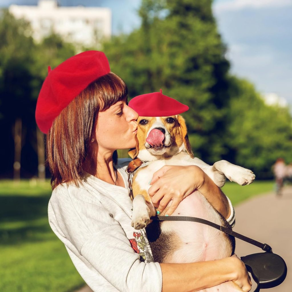 dog and owner wearing red berets
