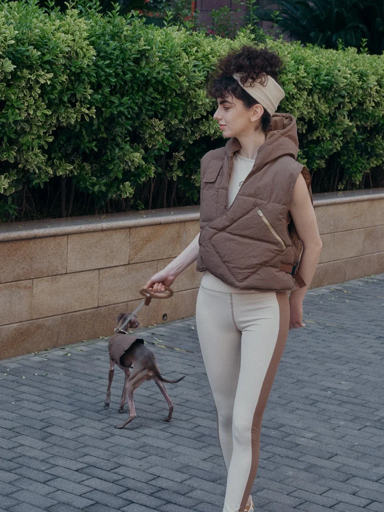 woman and dog wearing matching vests