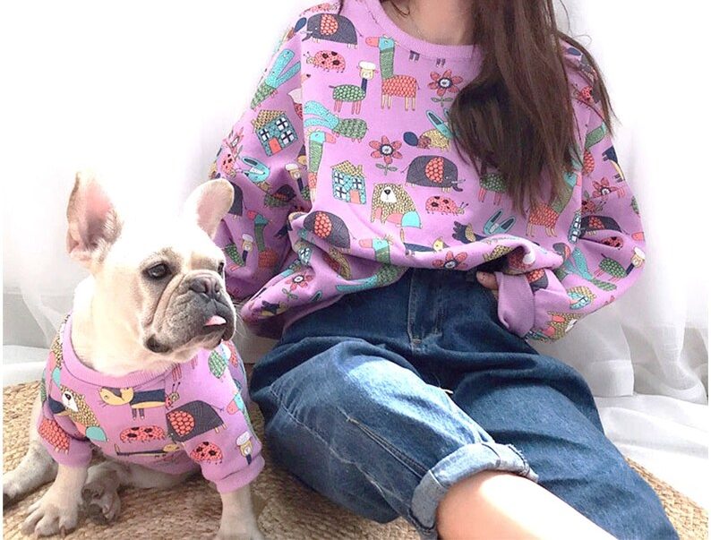 dog and girl wearing matching hoodies