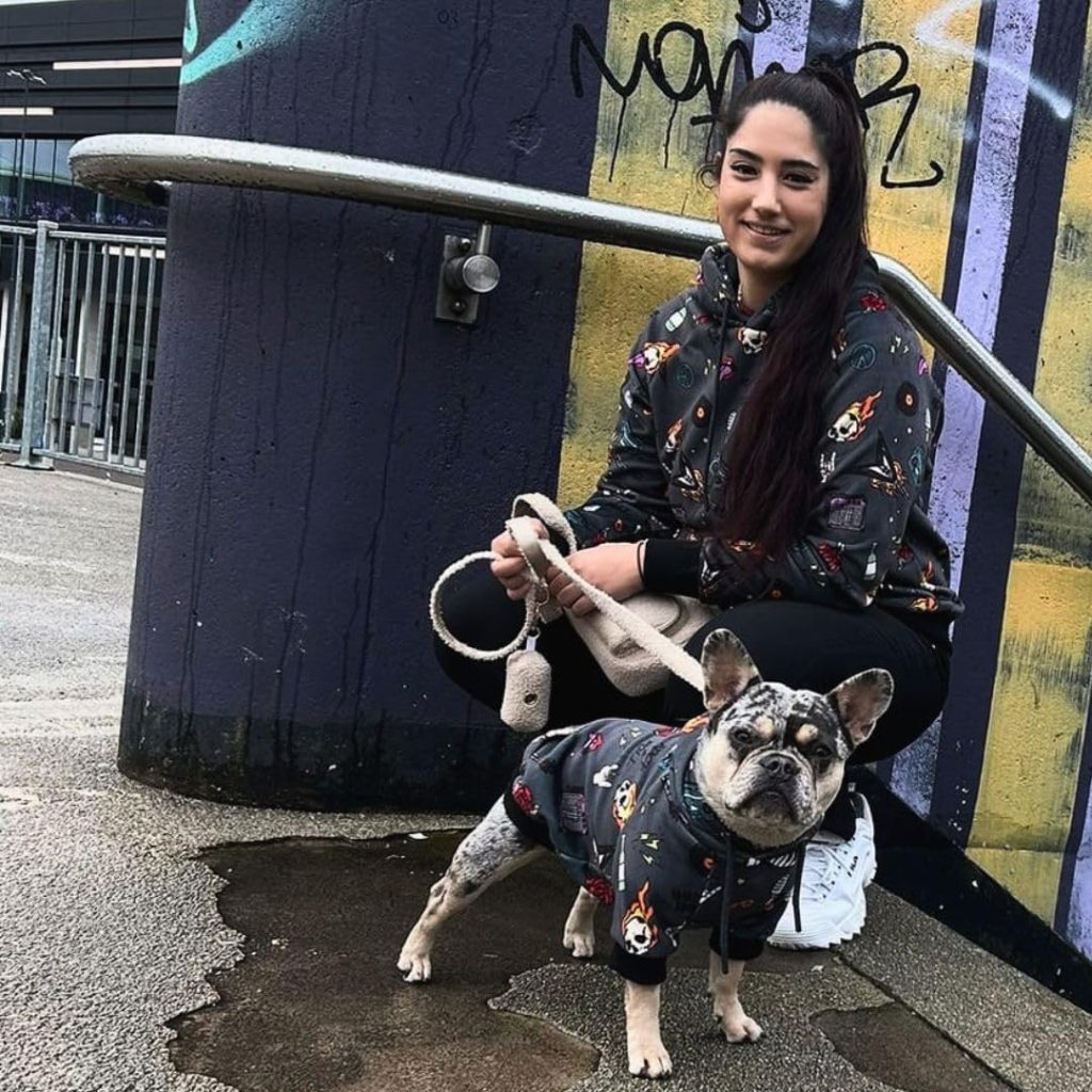 dog and woman wearing matching hoodies